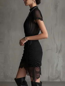 Detailed side view of black sheer lace spliced mini dress featuring elegant ruched texture