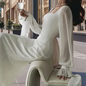 Elegant white square neck fishtail wedding dress with sheer long lantern sleeves.