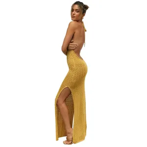 Detailed side view of a yellow knitted backless maxi dress with a sexy high slit.