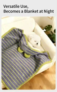 Soft purple and green striped hooded pet cloak used as a warm blanket for a sleeping puppy