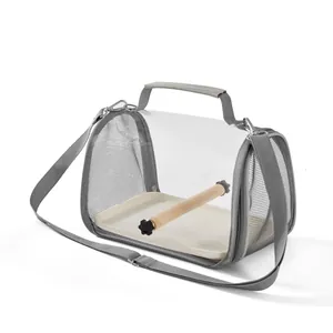 Side view of portable parrot carrier bag with clear front mesh sides and wooden perch