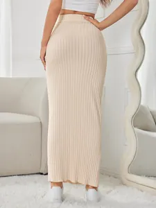 Close-up of beige ribbed knit maxi skirt featuring a bodycon fit and elastic waist