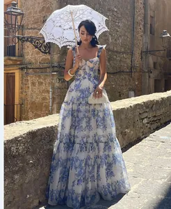 Detailed view of floral organza maxi dress with off-shoulder evening gown design