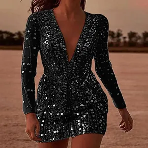Detailed view of sexy deep V-neck long sleeve sequined bodycon dress at sunset