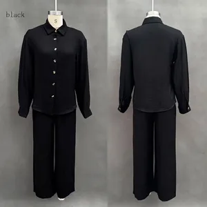 Front and back view of a black long-sleeve shirt and wide-leg pants set for women