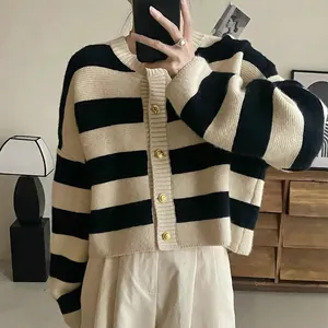 Detail of striped knit cardigan for women with elegant gold buttons and black beige pattern
