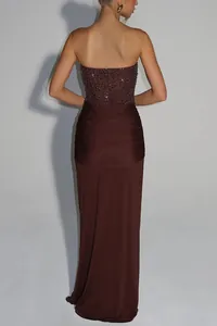 Detail showing the elegant sequined back and ruched skirt of this brown maxi dress.