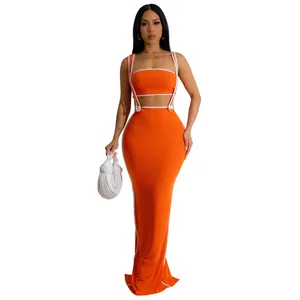 Vibrant orange two-piece set featuring a ribbed crop top and matching bodycon maxi skirt