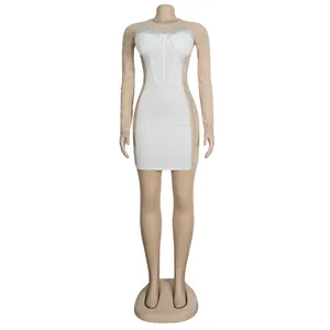 Close-up view of elegant white rhinestone corset dress with sheer mesh long sleeves