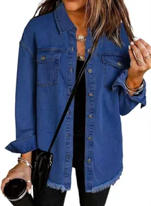 Detail of women's washed denim jacket with trendy distressed raw hem and button pockets
