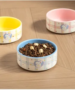 Detail of ceramic pet bowl filled with dry food and freeze-dried snacks.