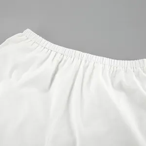 Close-up detail showing the elastic waistband of these white cotton linen shorts for summer