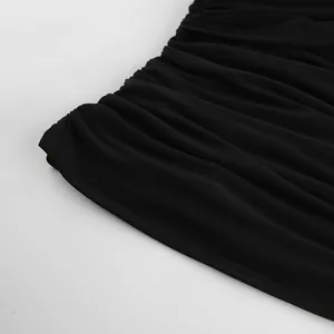 Detailed close-up showing the fine black sheer mesh fabric and ruched textures