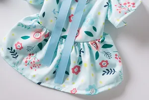 Close-up detail of the floral print and light blue ribbon on this summer dog dress