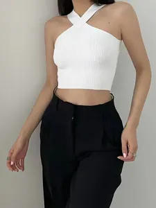 Close-up of white halter-neck ribbed crop top showing detailed knit texture on model