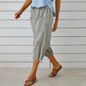 Detailed side view of grey cotton linen cropped pants featuring decorative buttons on the hem