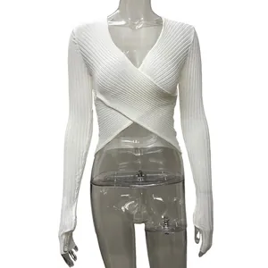 Elegant white ribbed knit cropped top with long sleeves and sexy crossover front detail