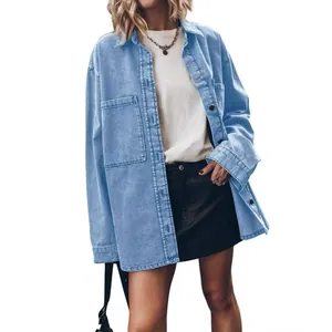Close-up detail of women's retro oversized light blue denim shirt with large front pockets