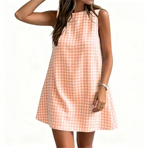 Close-up of sleeveless summer dress featuring classic orange and white gingham pattern