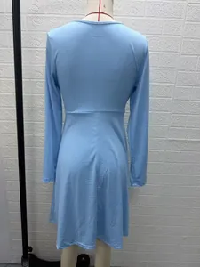 Detailed back view of a light blue long-sleeved V-neck midi dress on a studio mannequin