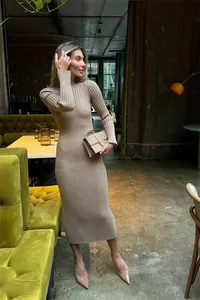 Elegant long sleeve beige ribbed knit midi dress for women shown in a cafe setting