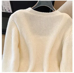 Detailed macro view of cream-colored French knit cardigan's soft texture.