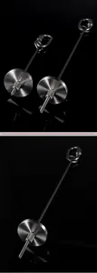 Macro detail of a stainless steel fruit skewer with a hanging hook for pet birds