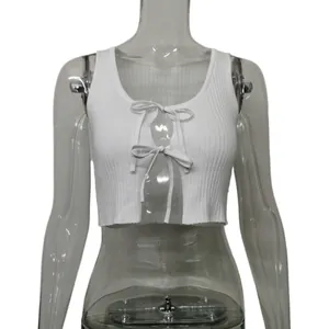 Detailed view of white ribbed knit crop top featuring sexy front tie-up bows design