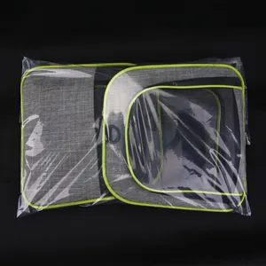 Foldable gray pet carrier bag with green trim inside clear retail plastic packaging