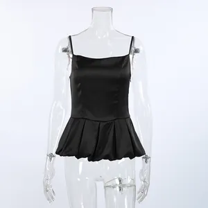 Elegant black satin peplum camisole top with thin straps and waist-slimming design.