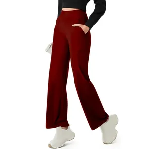 Detail view of women's high-waisted burgundy yoga pants featuring functional side pockets.