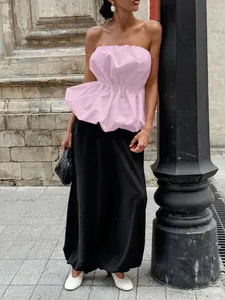 Elegant pink strapless ruffled tube top with waist slimming detail for summer outfits
