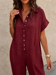 Close-up of a burgundy short-sleeve jumpsuit with a button-down front and collar.