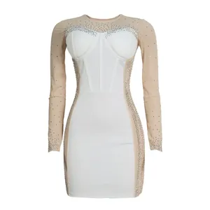 Detailed view of white slim dress with sheer rhinestone sleeves and corset bodice