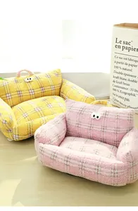 Detail of bouclé plaid pet sofas with cute eye decor and portable handles