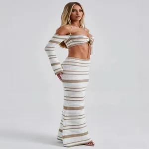 Two-piece striped crochet set with halter long-sleeve crop top and maxi skirt.