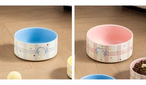 Detailed view of ceramic pet bowls featuring cute rabbit design and plaid pattern