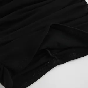 Close-up view of black mesh t-shirt fabric featuring ruched detailing and fine stitching