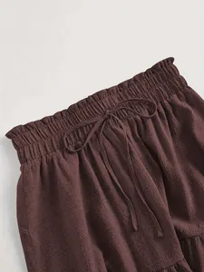 Detail of brown plus size skirt featuring elastic paper-bag waist and drawstring.