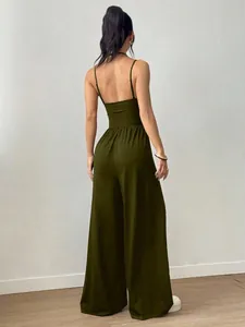 Back view of a dark green spaghetti strap wide-leg jumpsuit with an open back design
