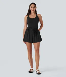 Full body view of a black sleeveless athletic dress romper with side pockets for women