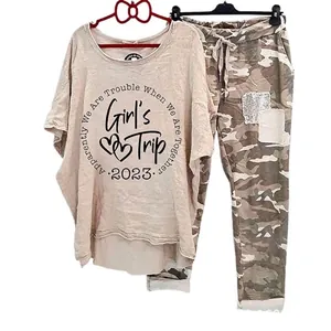 Stylish womens casual two piece set featuring beige graphic t-shirt and camo pants