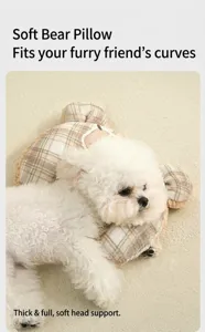 Soft plaid bear-shaped pet pillow providing comfortable head support for a small white dog