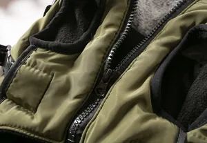 Detailed macro view of the black zipper and warm grey fleece lining on pet winter vest