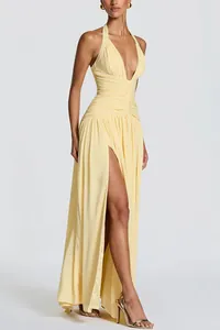 Elegant pale yellow deep V-neck halter maxi dress with high slit and ruched waist detail