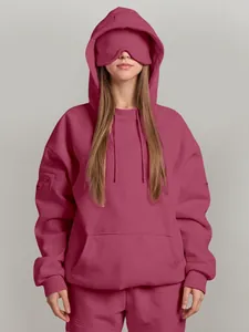Oversized rose pink hoodie with integrated eye mask for comfortable travel and lounge