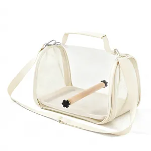 Detail view of portable bird carrier travel bag with mesh sides and a wooden perch
