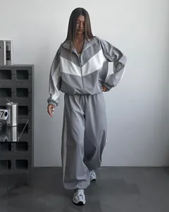Grey and white color-block tracksuit set for women featuring loose zip-up jacket
