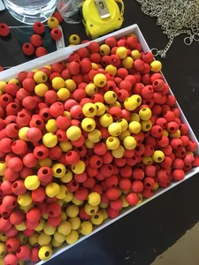 A bulk collection of high-quality red and yellow wooden beads for DIY parrot bird toys
