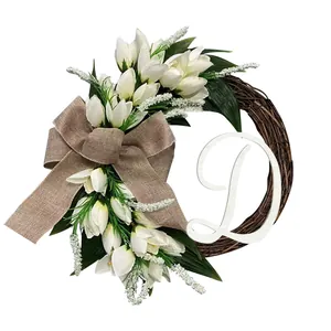 Detailed view of artificial white tulip wreath with burlap bow and large cursive letter D